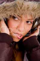 close up of adult woman with woolen coat listening music