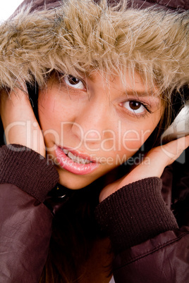 portrait of adult female with woolen coat listening music