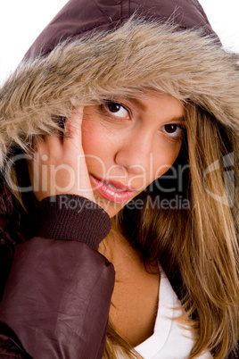 portrait of young female with winter coat looking at camera