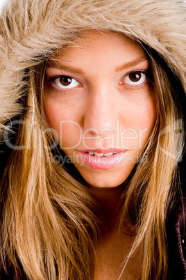 portrait of young woman with winter coat looking at camera