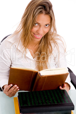 top view of smiling student reading book