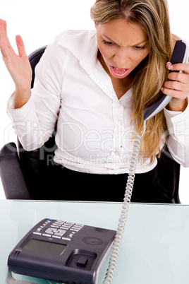 top view of surprised businesswoman holding receiver