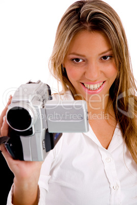 portrait of smiling woman recording through handy cam
