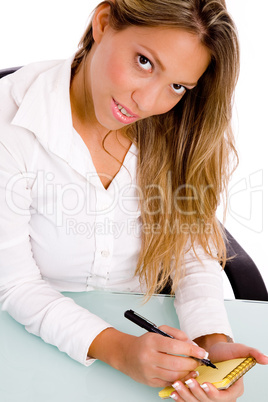 top view of businesswoman writing on paper