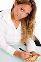 top view of businesswoman writing on paper