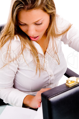 top view of surprised businesswoman looking document