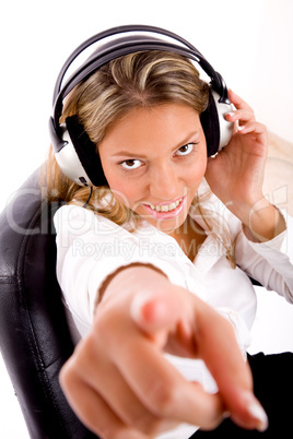 top view of manager listening music and pointing at camera