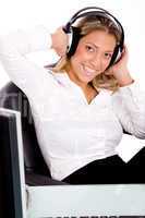 front view of smiling businesswoman listening music