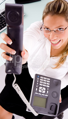 top view of smiling employee showing phone receiver