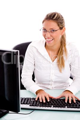 front view of smiling manager working on computer