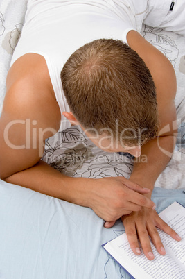 fit man reading book while resting