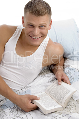 smart male reading book with great interest