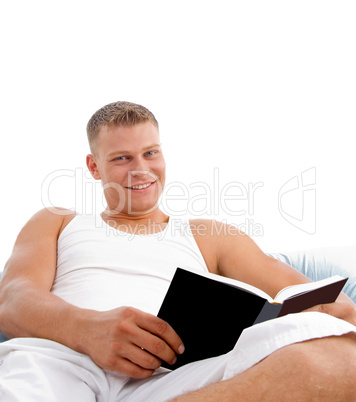 man reading book in bed