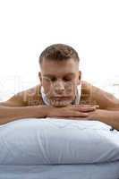 young man relaxing on bed