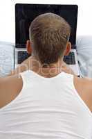 back pose of man working on laptop