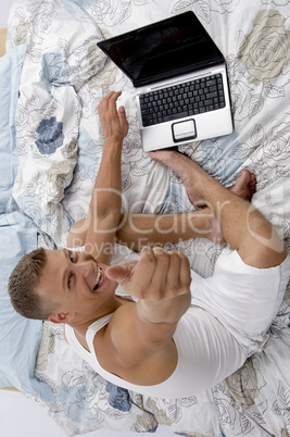 man with laptop and thumbs up