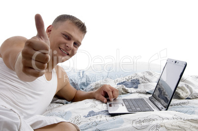 man with laptop and thumbs up