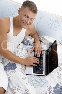 smiling man working on laptop