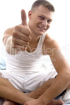 sitting young man showing thumb up