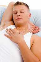 sleeping man putting hand on his chest