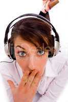 front view of surprised woman listening to music