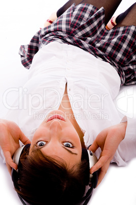 high angle view of woman looking at camera and listening to musi
