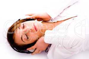 side pose of woman lying down on floor tuned to music