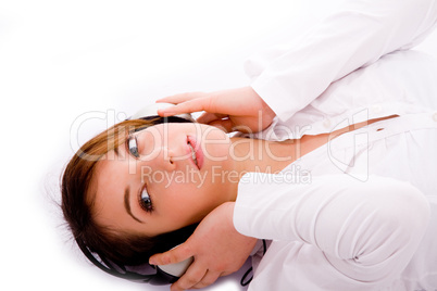 high angle view of woman tuned to music lying down