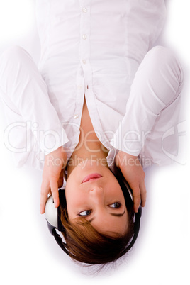 high angle view of woman lying down and enjoying music