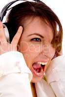 side pose of screaming woman listening to music