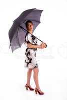 full body pose of young woman holding umbrella
