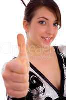 front view of smiling Japanese woman showing thumbs up