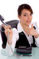 front view of happy businesswoman pointing at phone