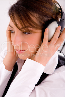 side view of female lawyer listening music in headset
