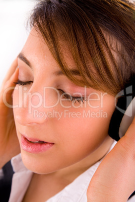 side view of corporate female tuned to music