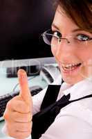 side view of happy businesswoman showing thumbs up