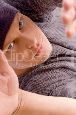 close up view of man's face posing with open palm