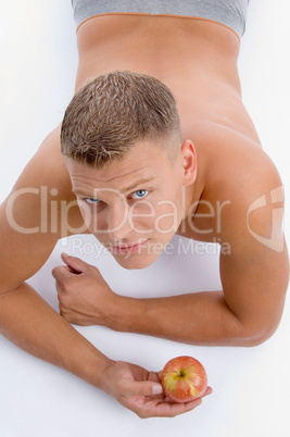 high angle view of muscular man with apple