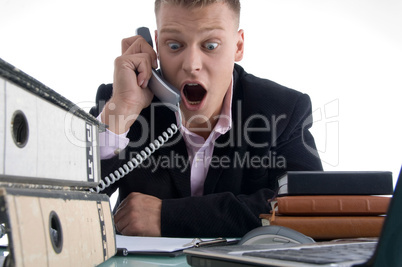 shocked businessman holding receiver