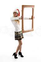 side view of female wearing christmas hat holding a frame