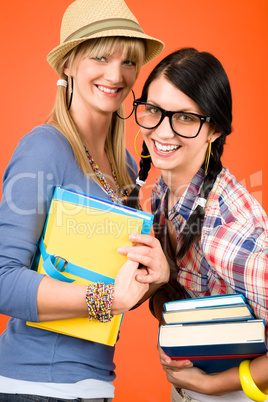 Two woman friends young students hold books