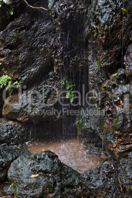 Waterfall on black basalt rock