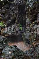 Waterfall on black basalt rock