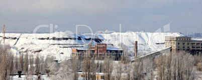 Metallurgical factory in the winter, slag mountain