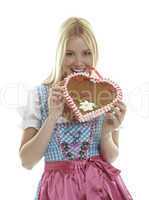 Woman bites in an empty German Gingerbread heart