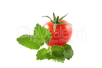 tomato with lemon balm on a white background