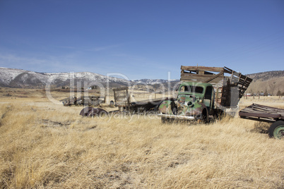 Old farm truck in a field of junk