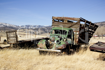 Old farm truck in a field of junk
