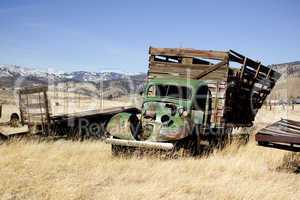 Old farm truck in a field of junk