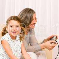 Grandmother and granddaughter play computer game